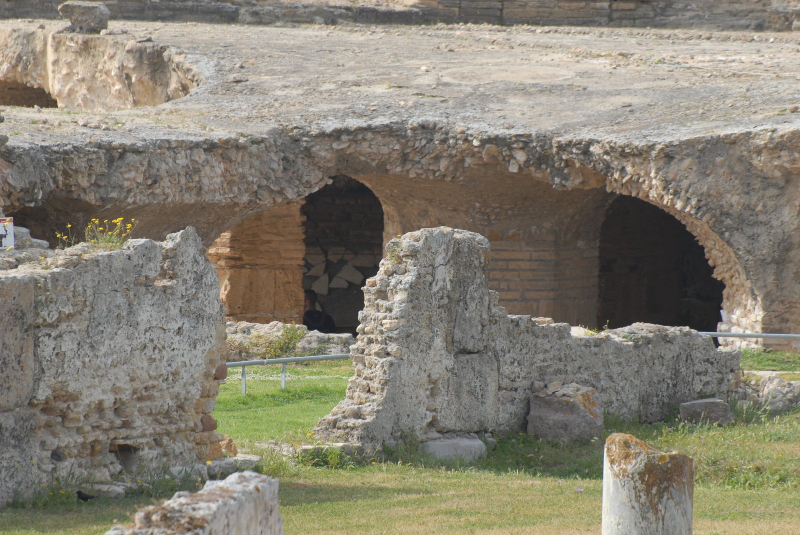 stone buildings and pillars, some with large round holes