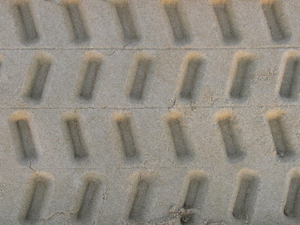 the wheels of an airplane on sand are making it look like they have wheels that are very high in the sand