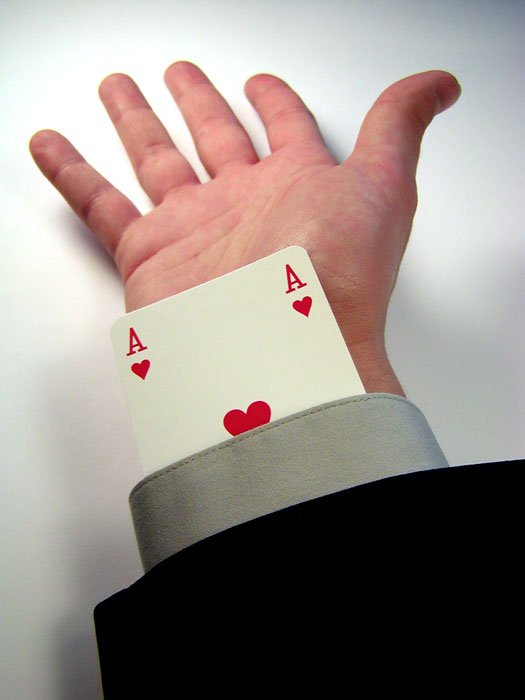 a person's hand is shown with playing cards