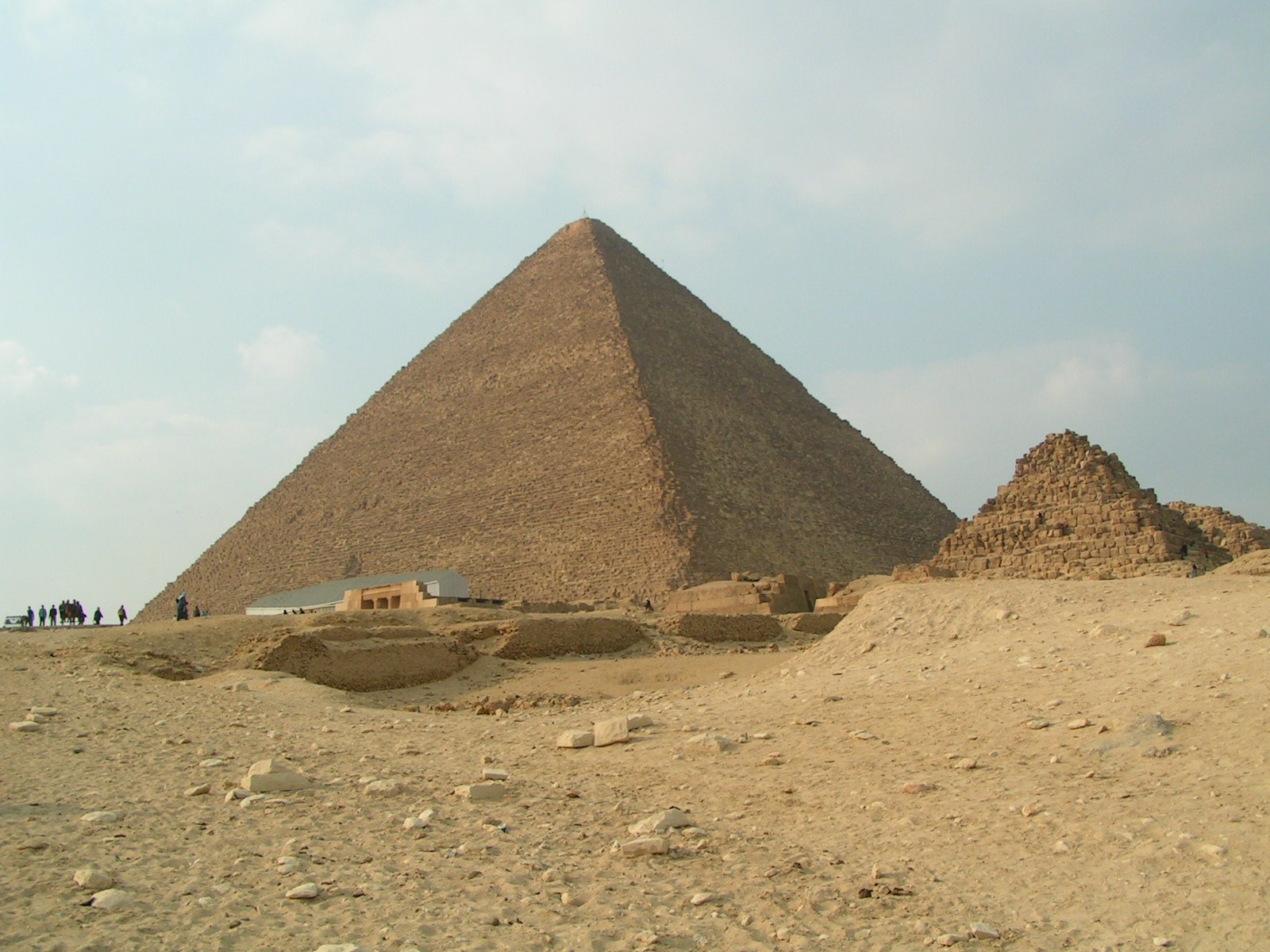 the great pyramid of giza, as seen from a small mound