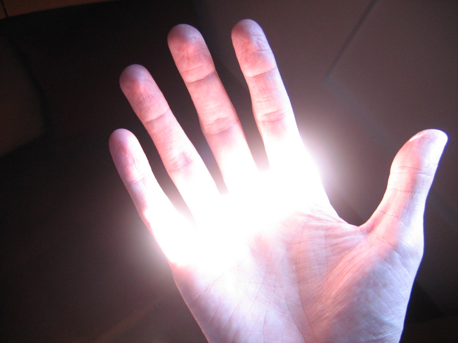 a person with their hands out with the light coming from them