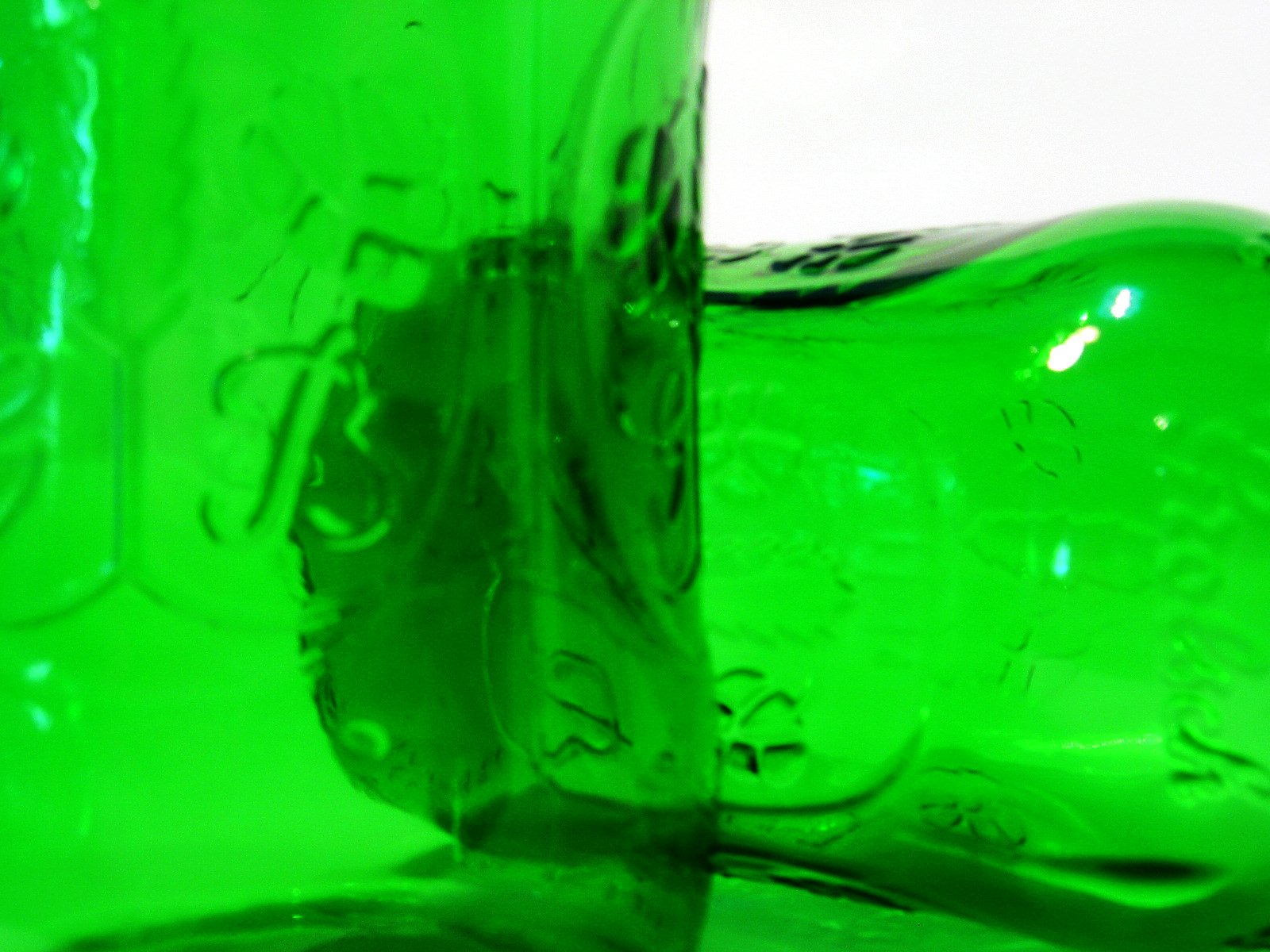 a green glass bottle with the lid open