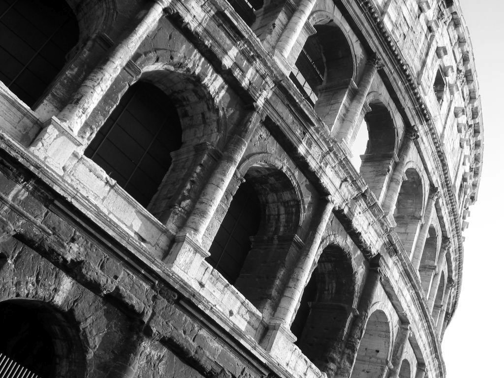 a large ancient building with circular windows in front of it