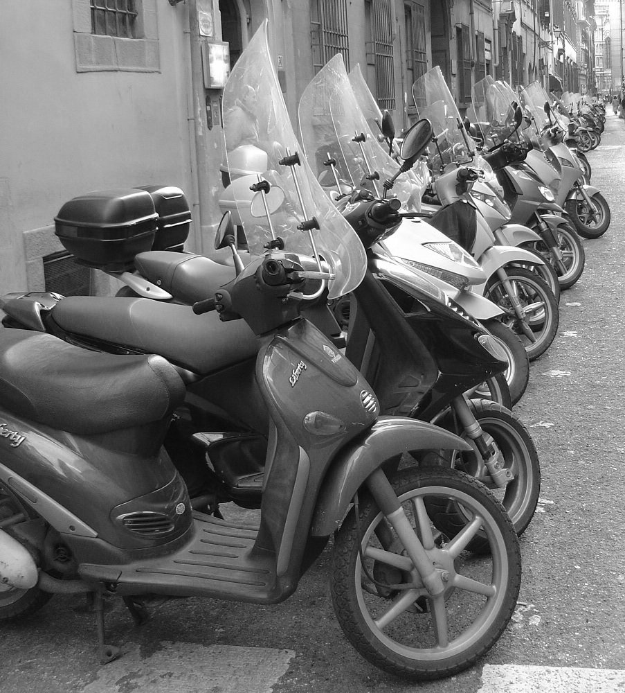 several motor scooters parked together next to each other