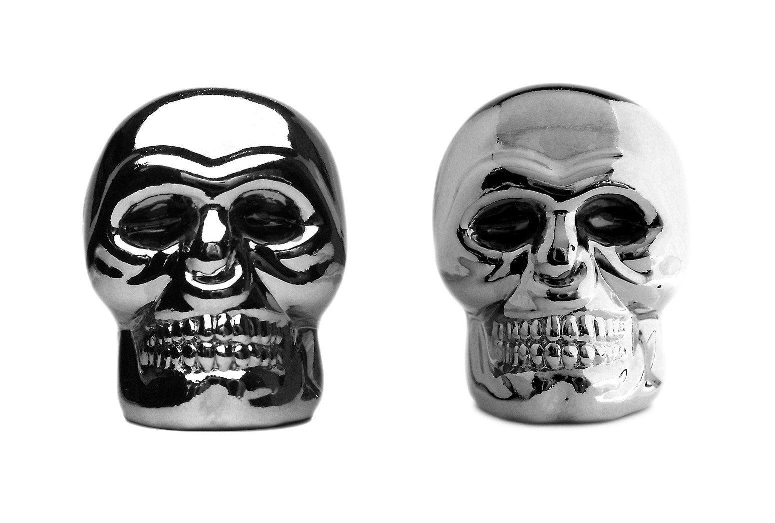 a pair of skull like vases sitting next to each other