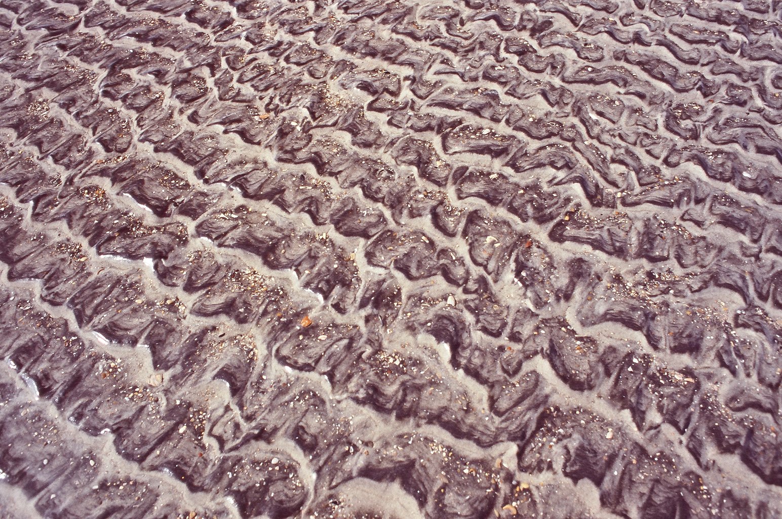 an abstract po of water and sand in the day