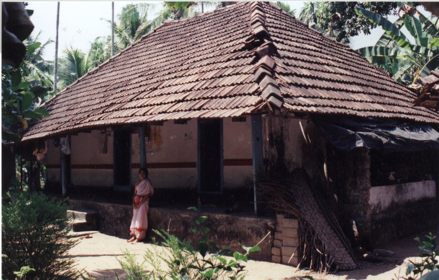 a women who is standing outside a small building