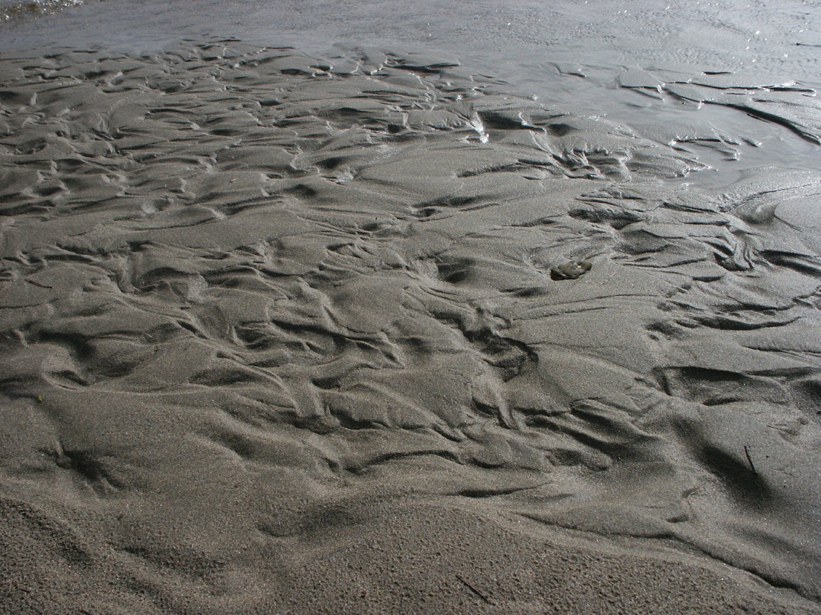 the beach is sand and water that covers many areas