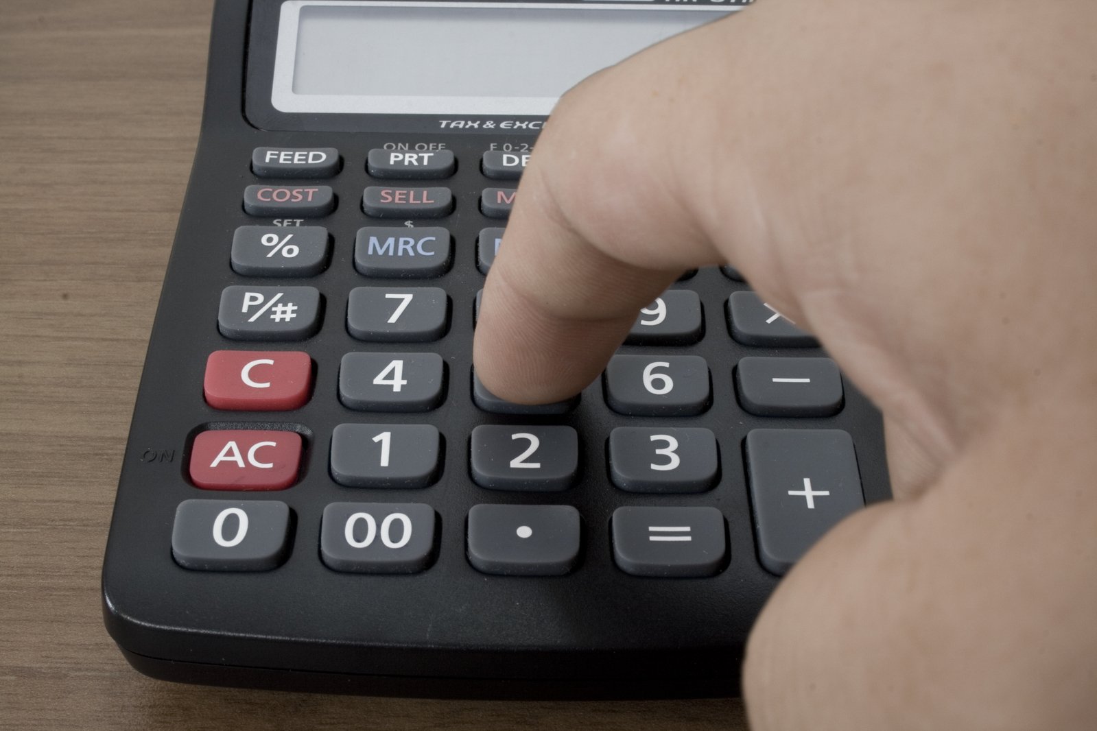 a person presses the numbers on the calculator