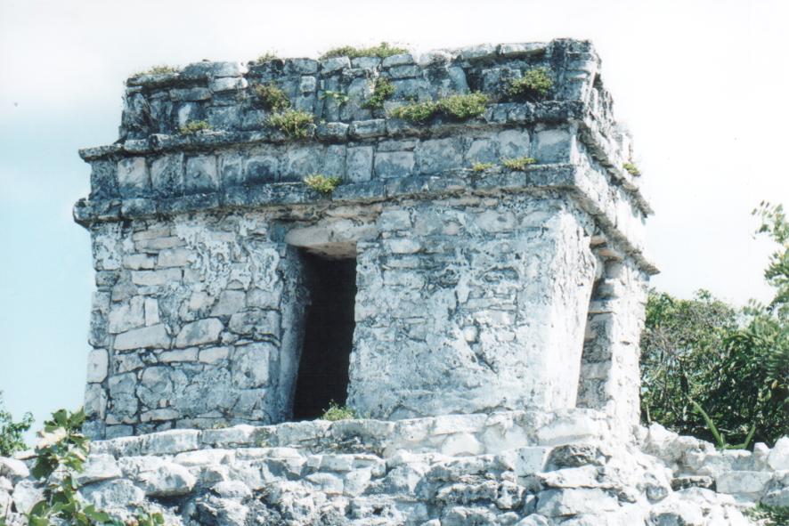 an old, crumbling stone structure with windows on the walls