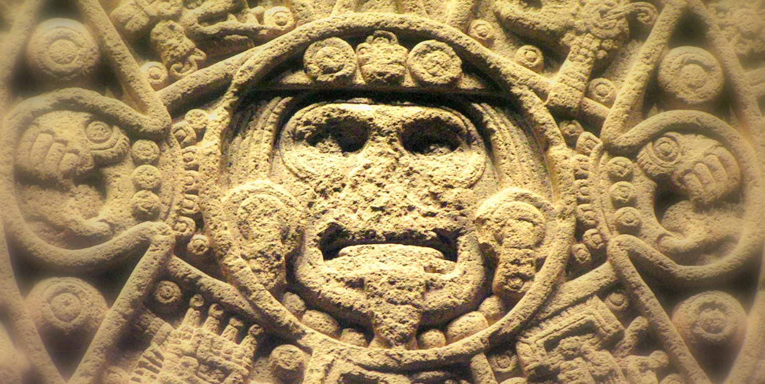 closeup of an intricately sculpted object with a face