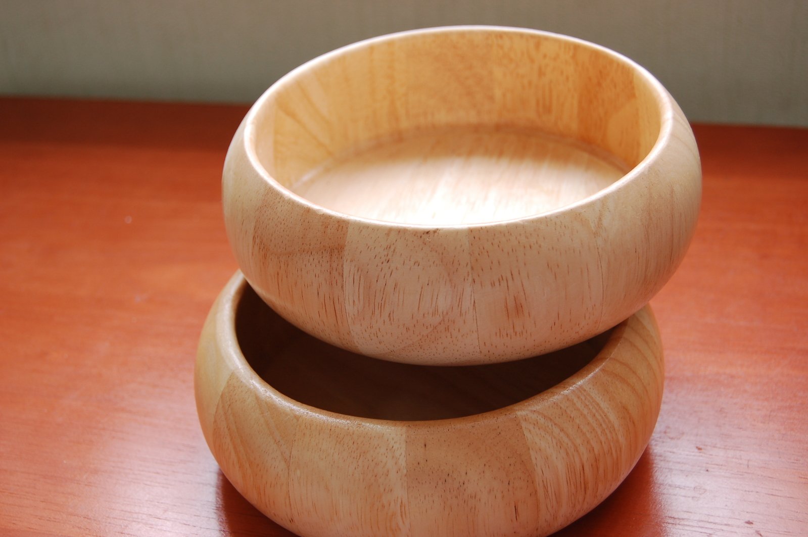 a close up view of two bowls on a wooden table