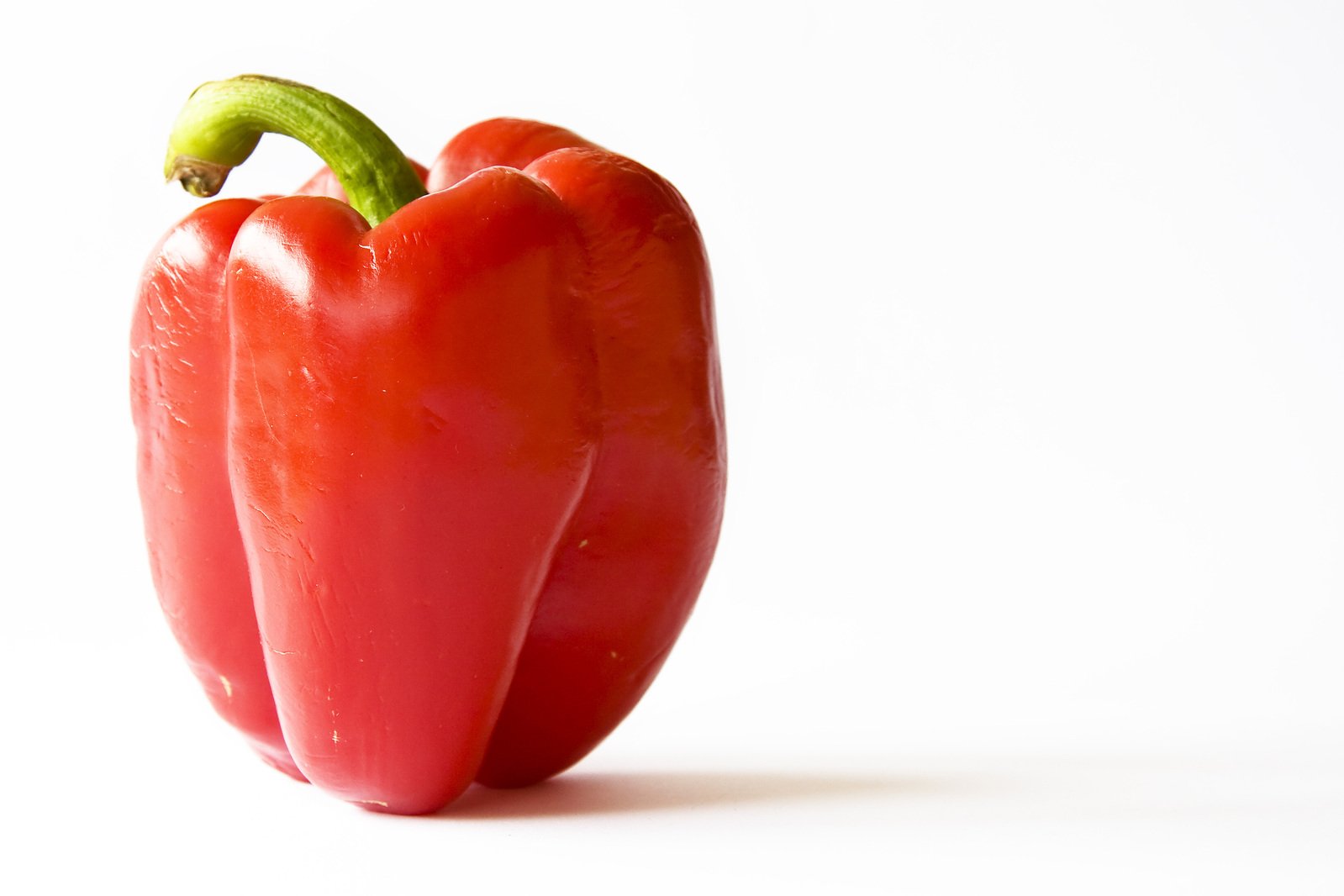 a red chili on the side of it with a green chilli pepper sticking out of the top