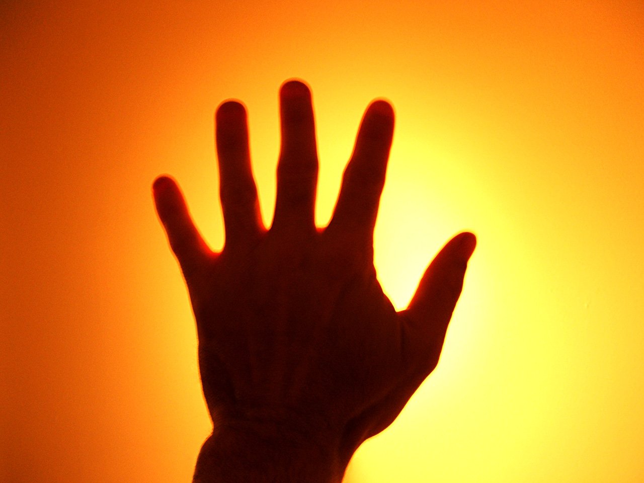 a hand reaches up to touch the sun
