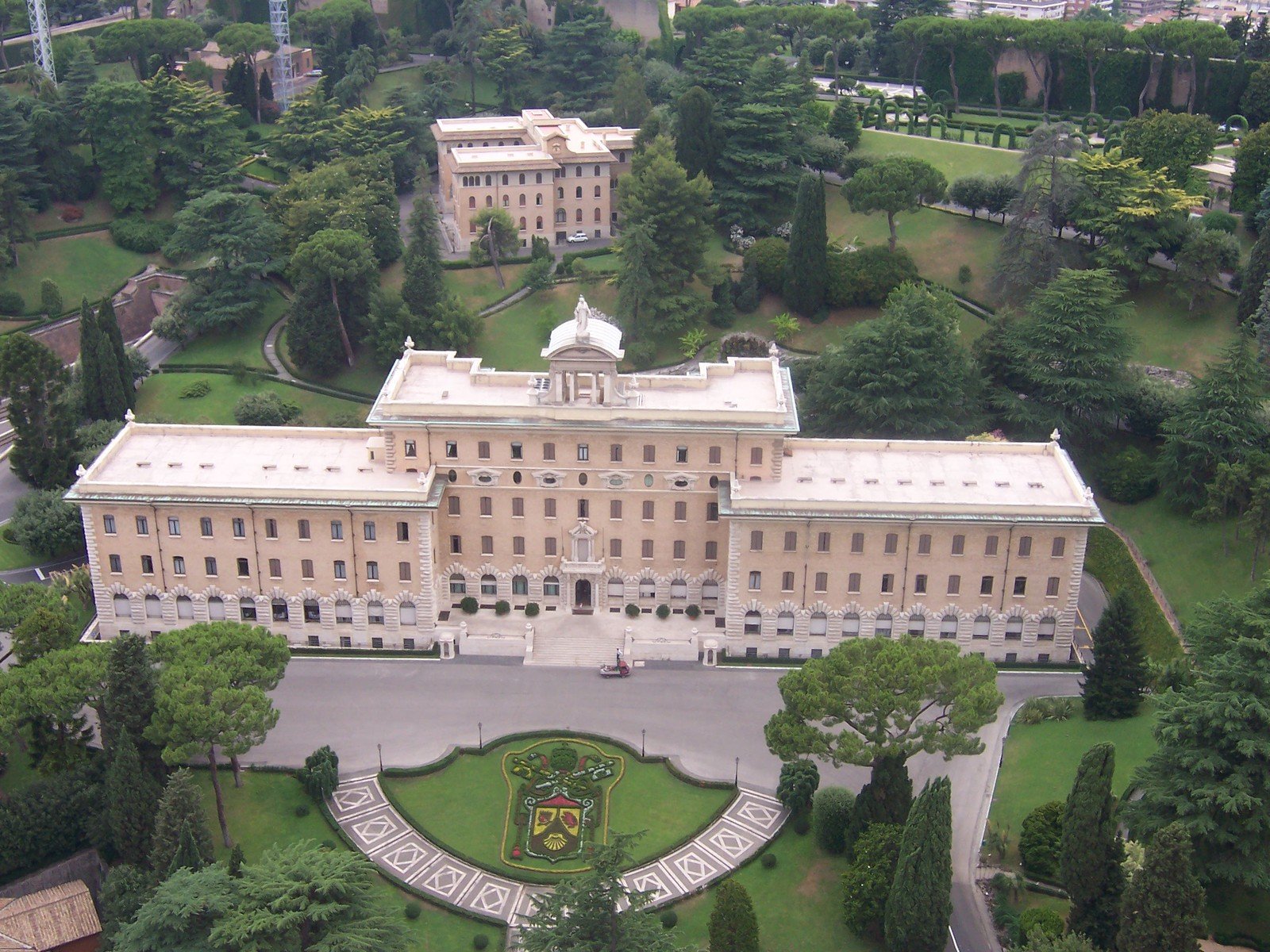 a large building on a huge green area