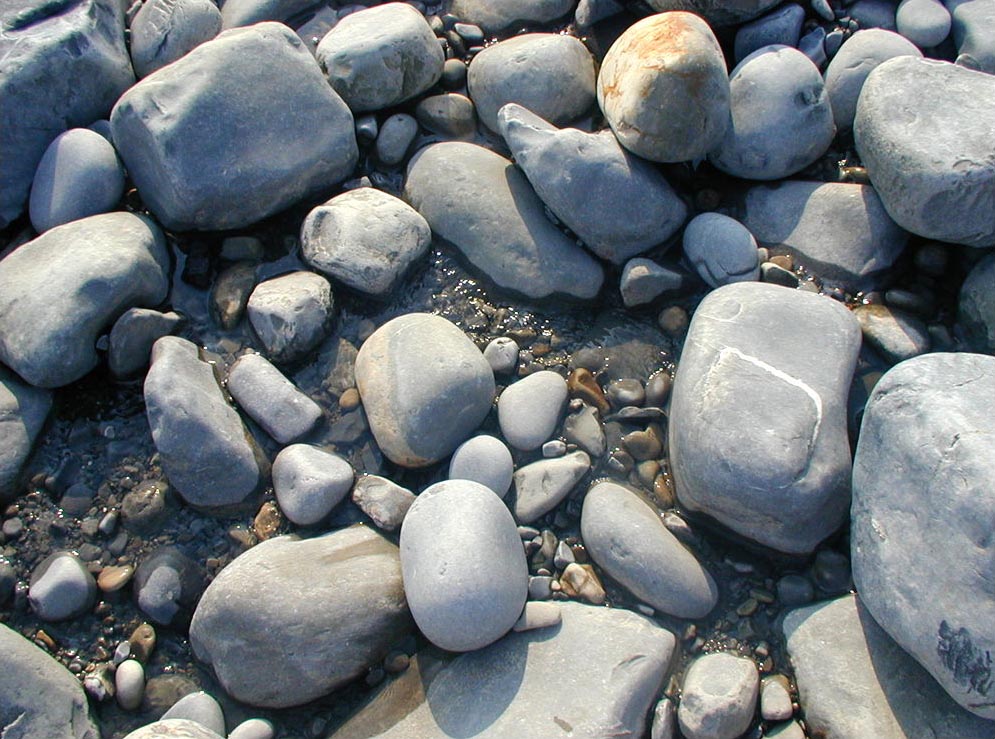 large rocks are on the ground with stones