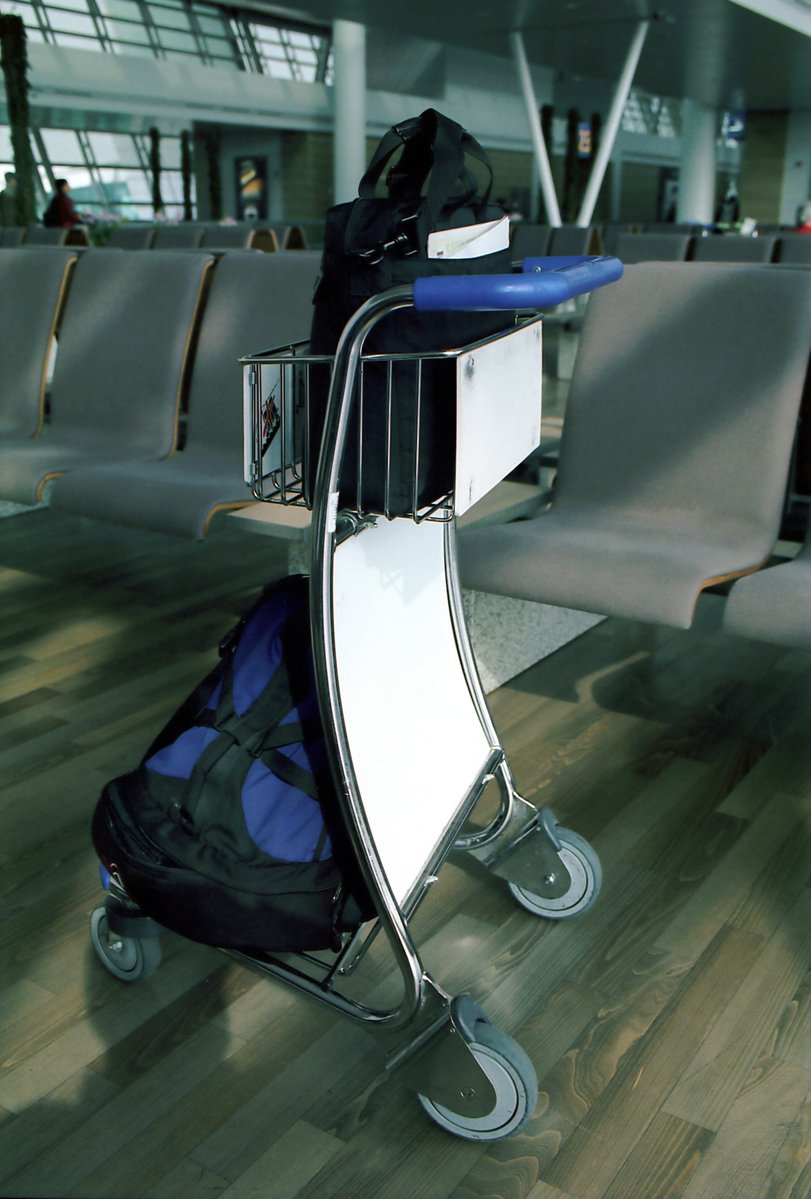 a metal cart with a luggage bag in it