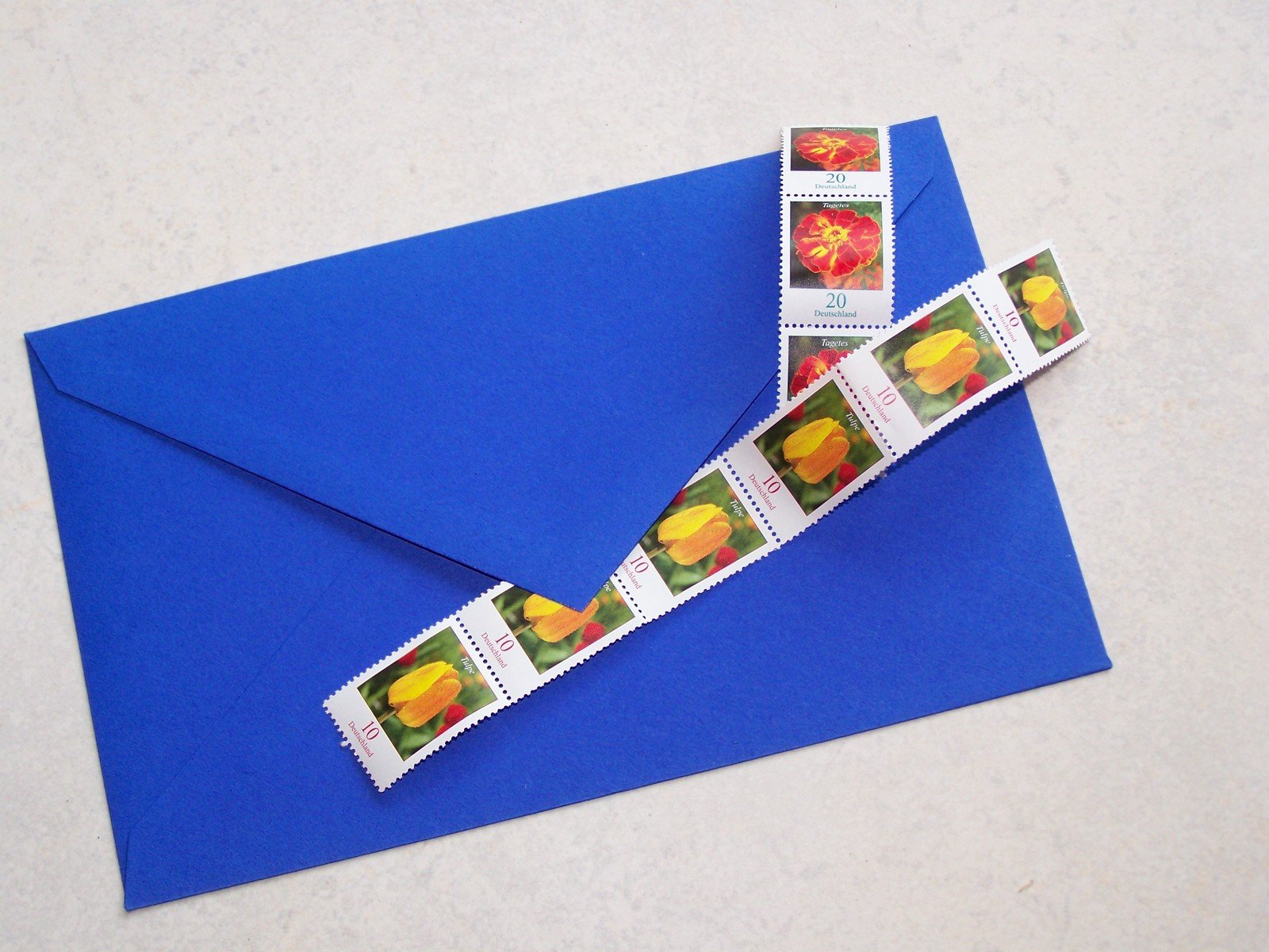 a close - up of a blue envelope containing postage stamps