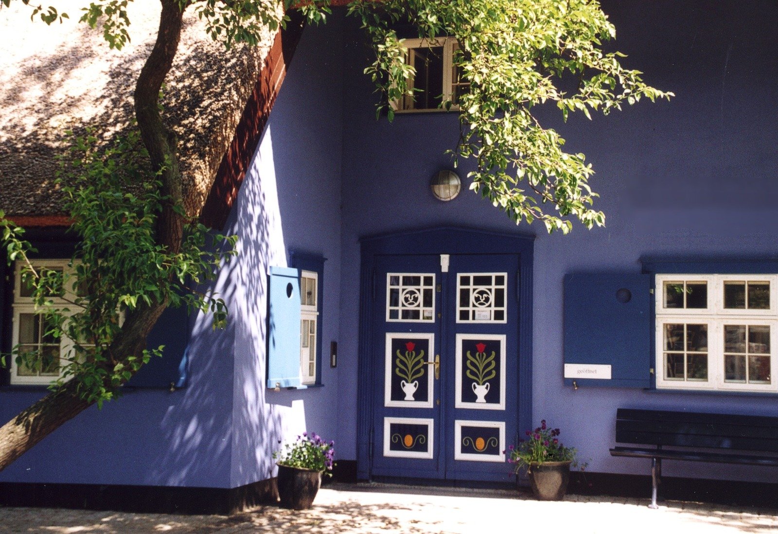 a building with a blue door and windows