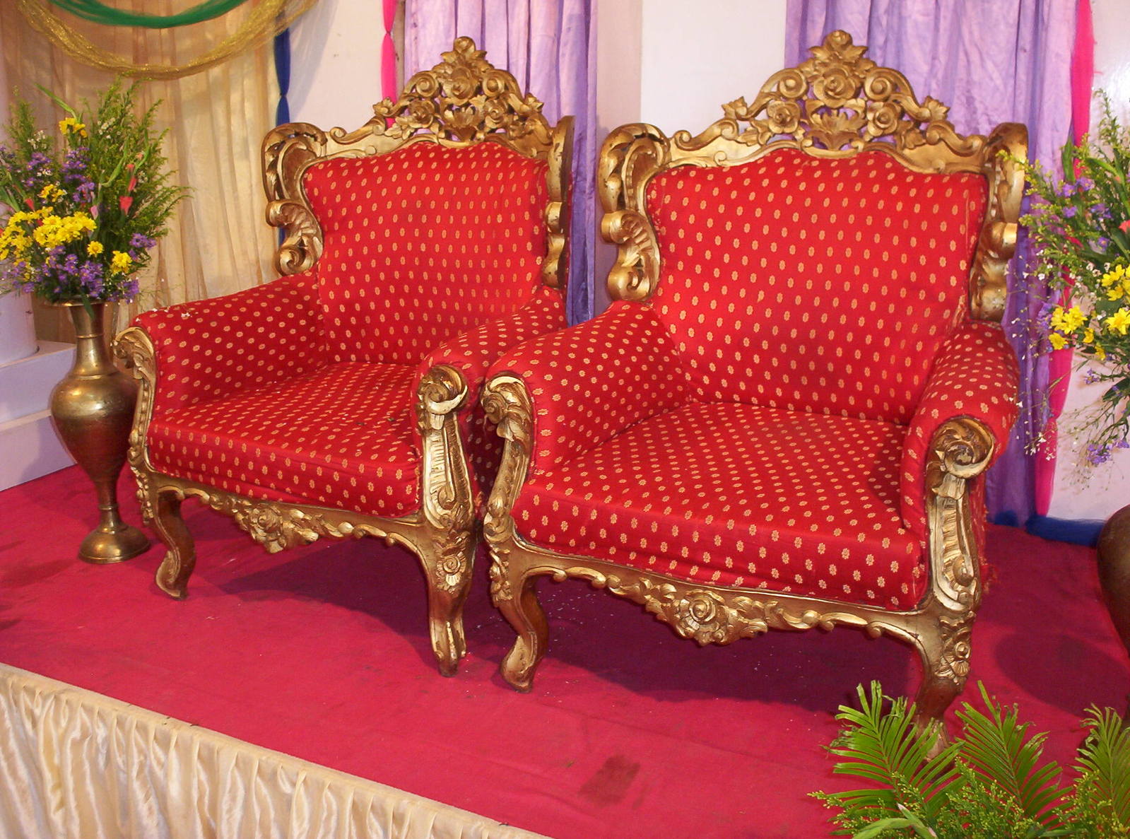 a red chair sitting on top of a pink stage