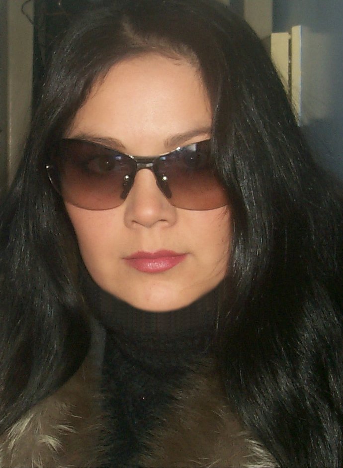 a woman wearing sunglasses looking off into the distance