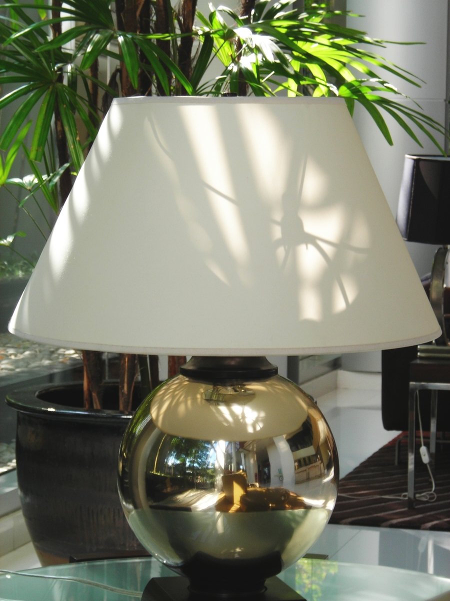 large glass table lamp in dim and modern home setting