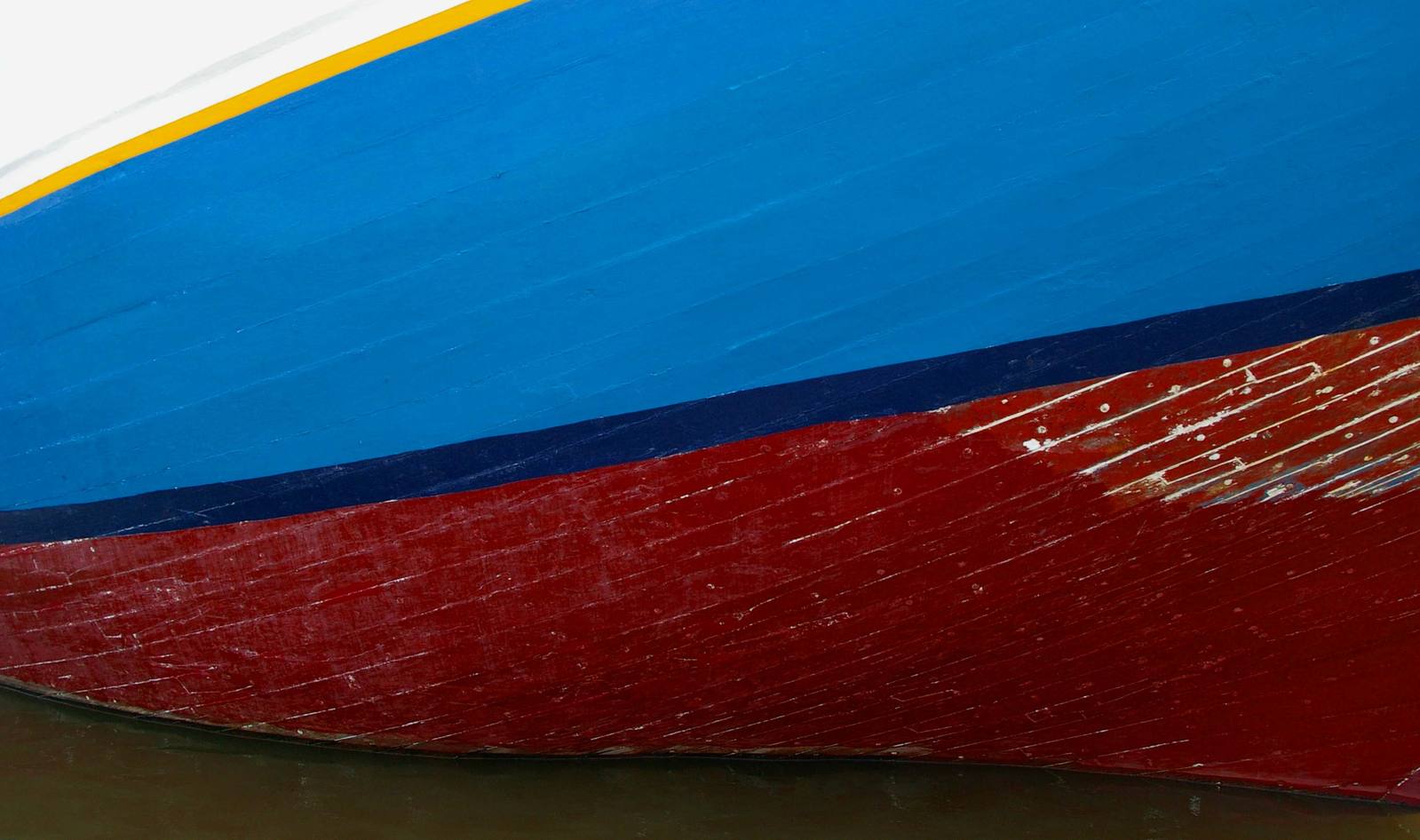 a large blue and yellow boat docked at a dock