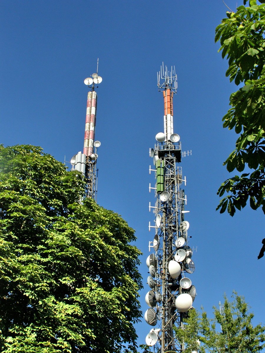 a telephone tower with multiple antennaes on it