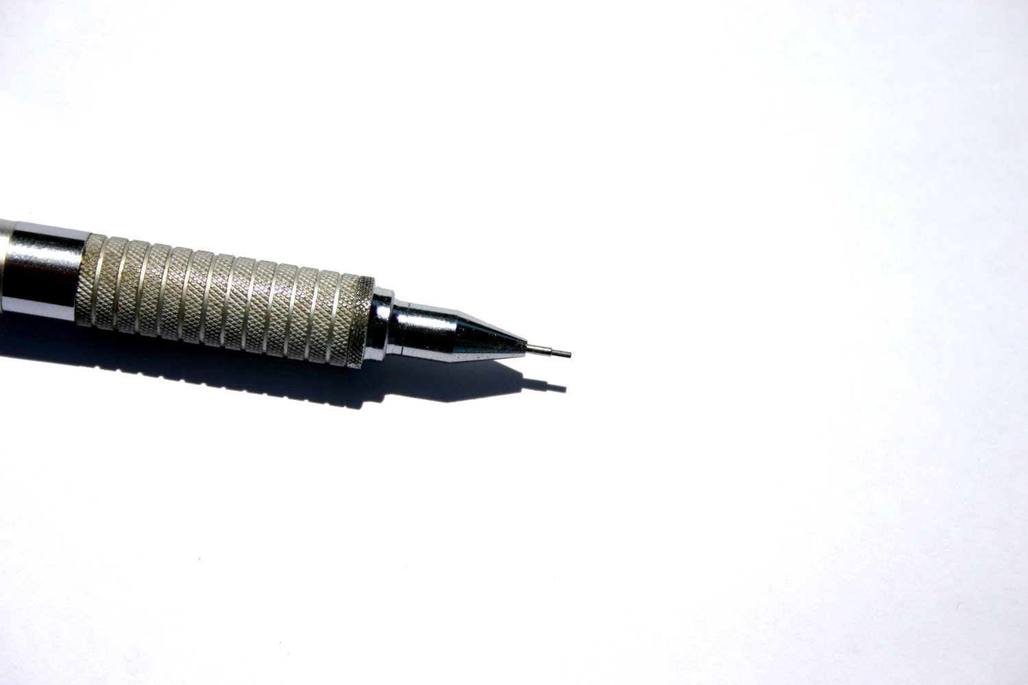 a small metal pen is on a white table