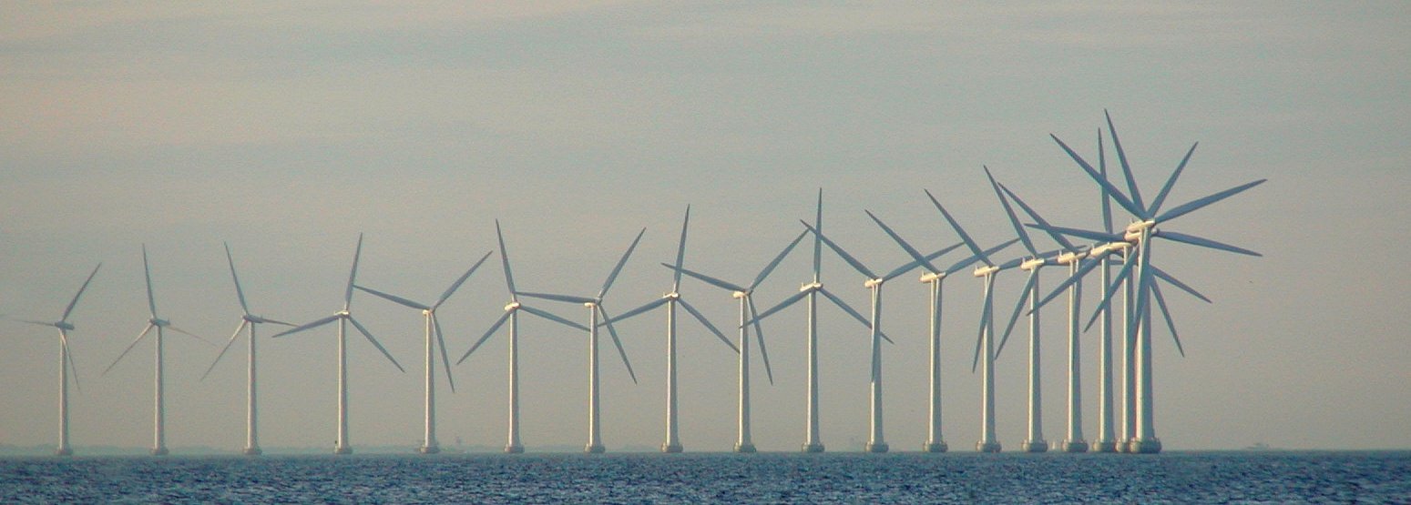 large group of wind mills floating across the water