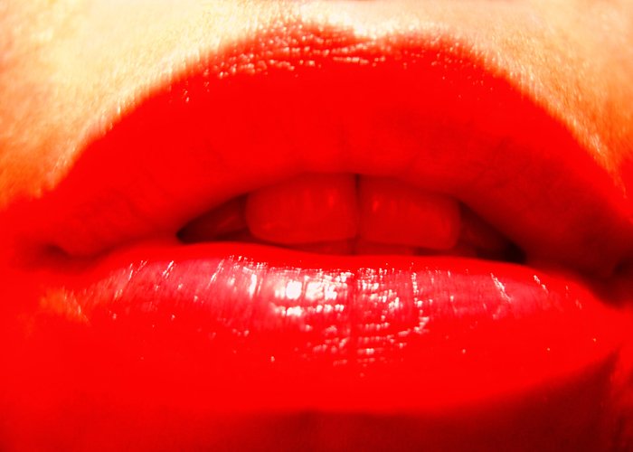 closeup of a red lip with a white background