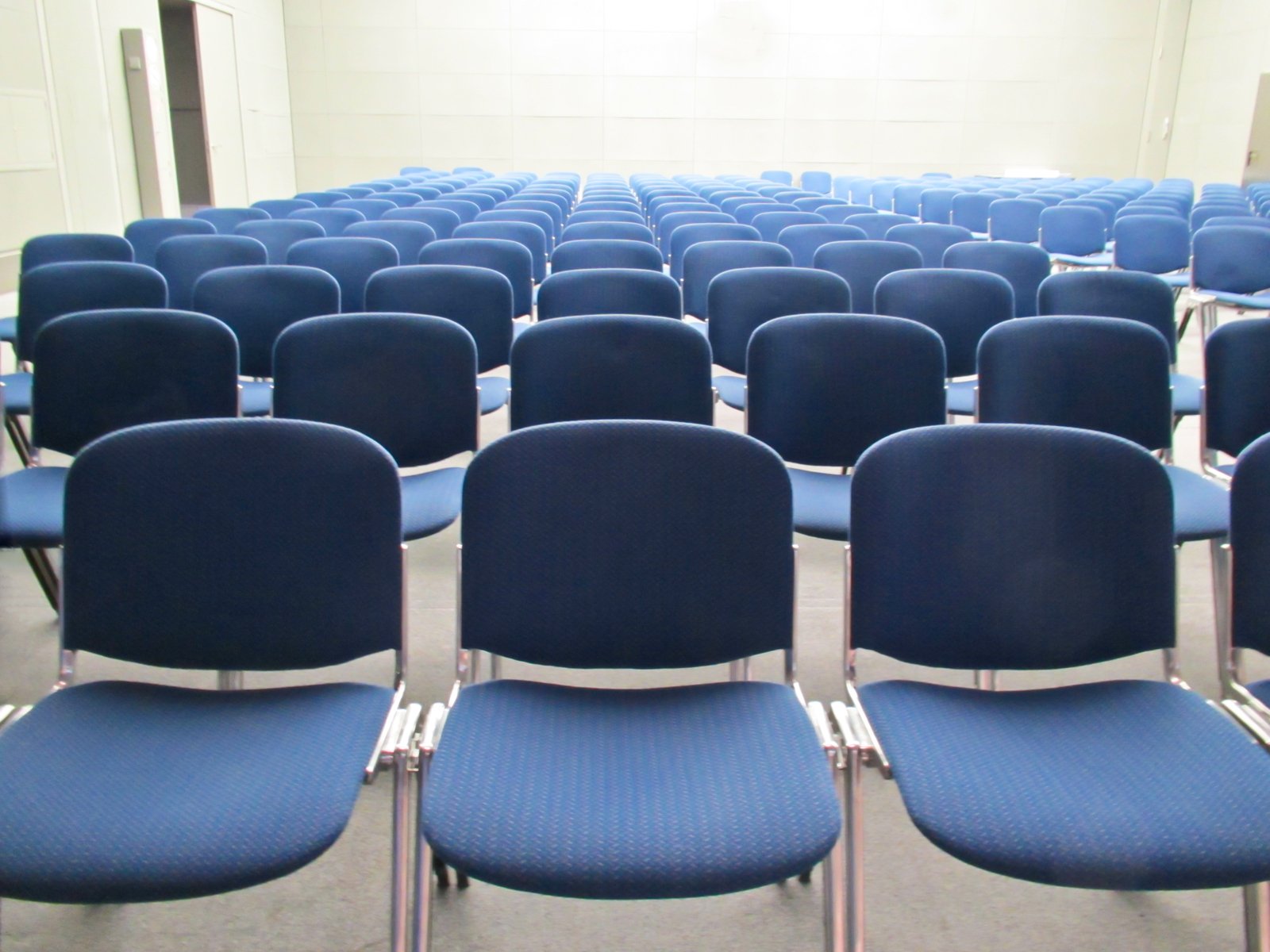 rows of blue chairs with rows of white ones