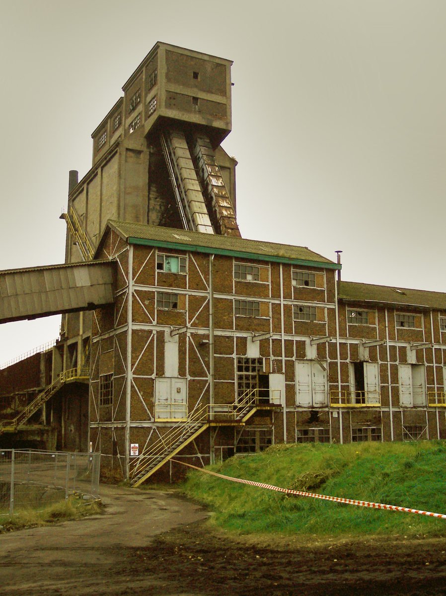 an old building with several stairs and a gated in area