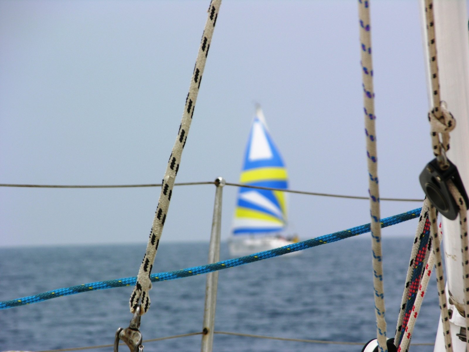 a boat with a sail near the back on the water