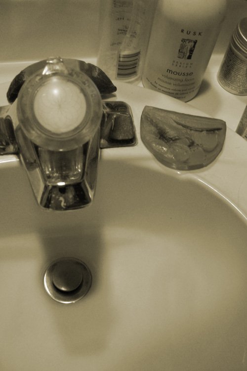 a sink that has different bottles on top