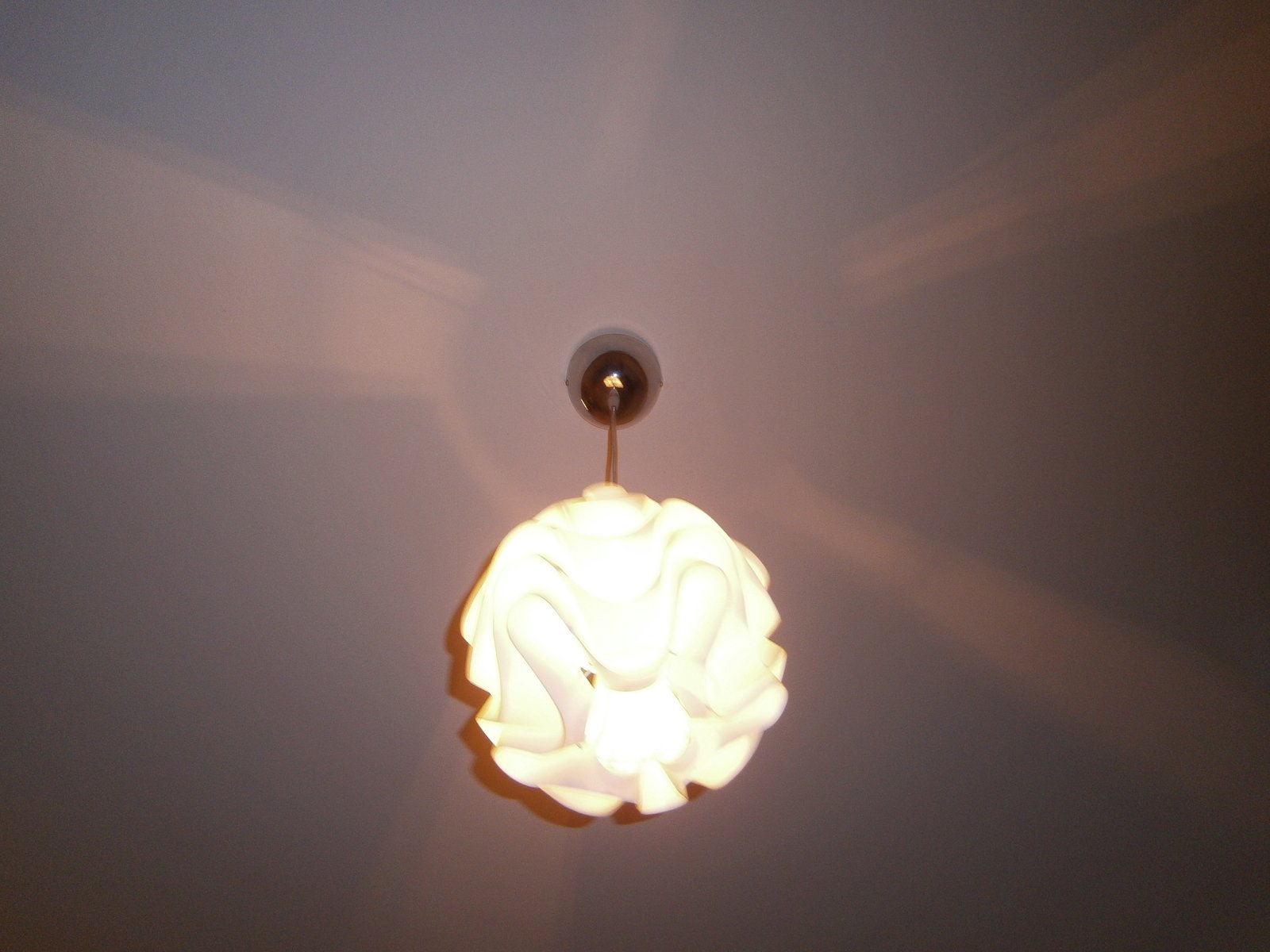 an illuminated light bulb on the ceiling in the room