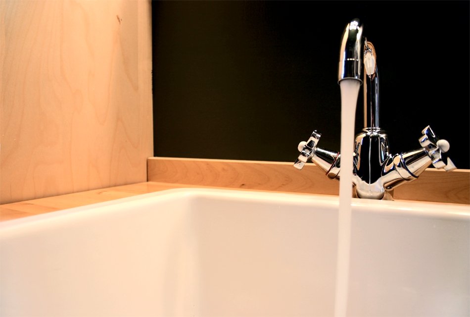 a large bathtub faucet that is next to a tub