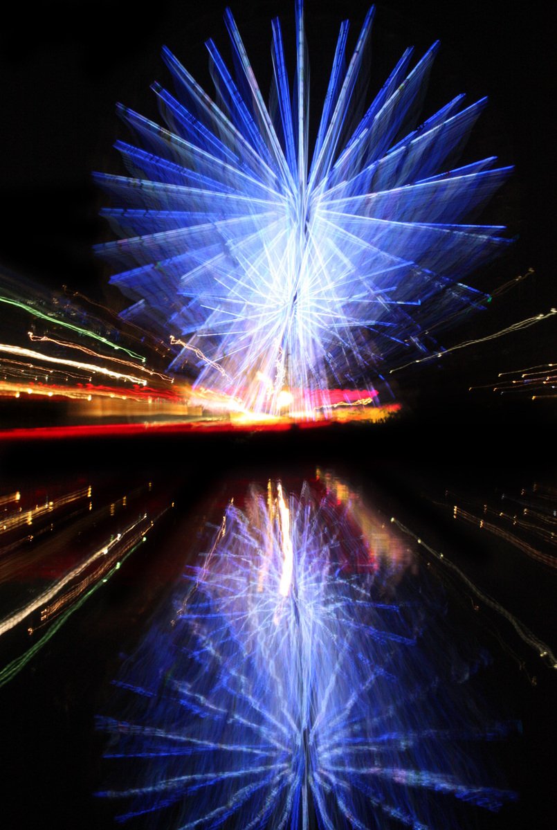 colorful fireworks reflected in water on night sky