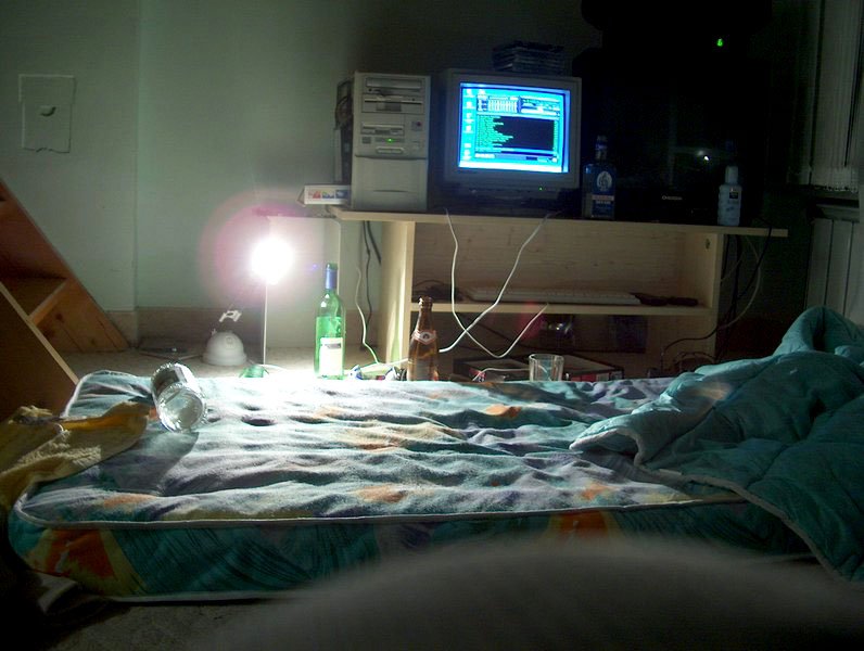 there is a television that is on and next to a bed