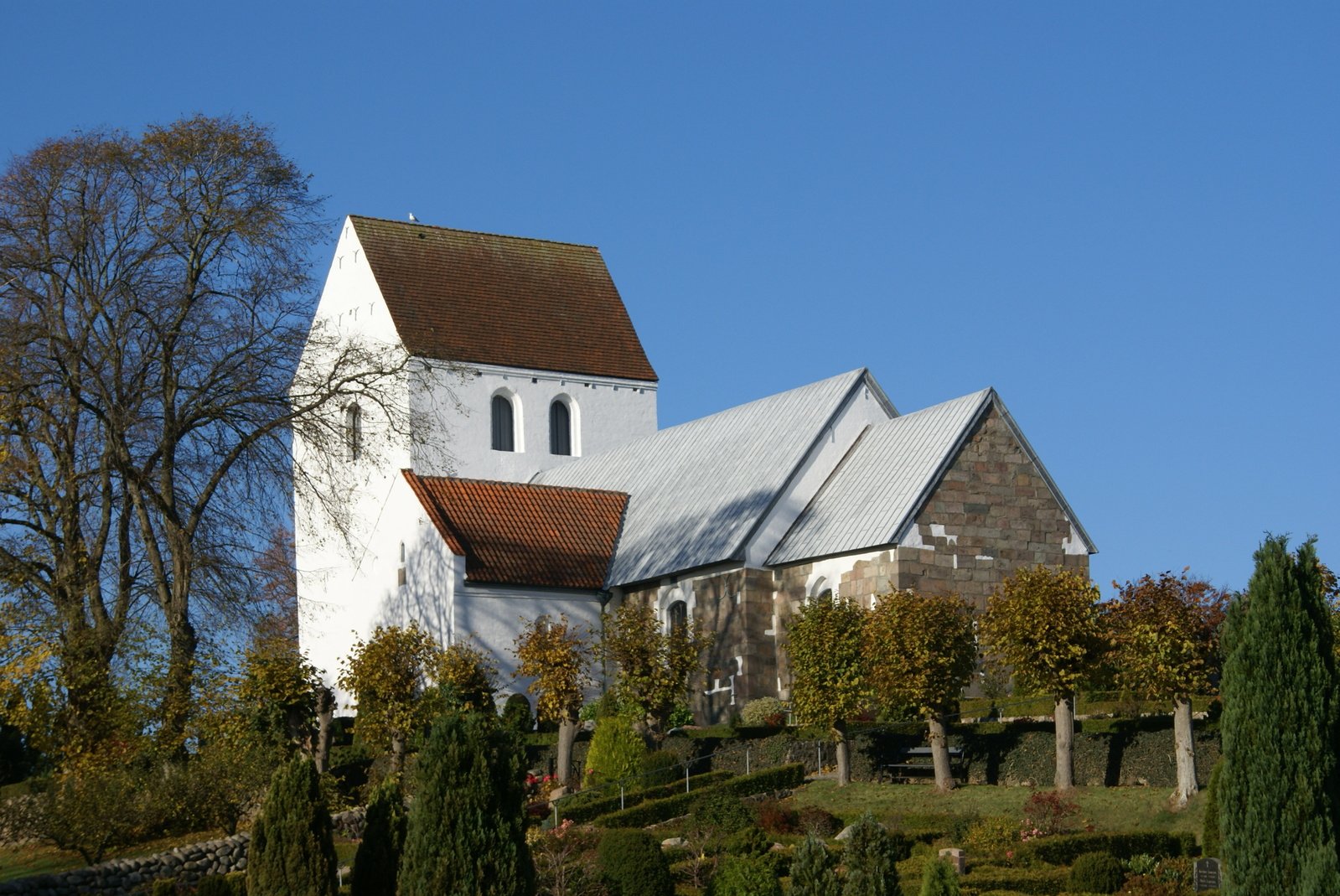 the church sits on a hill overlooking trees
