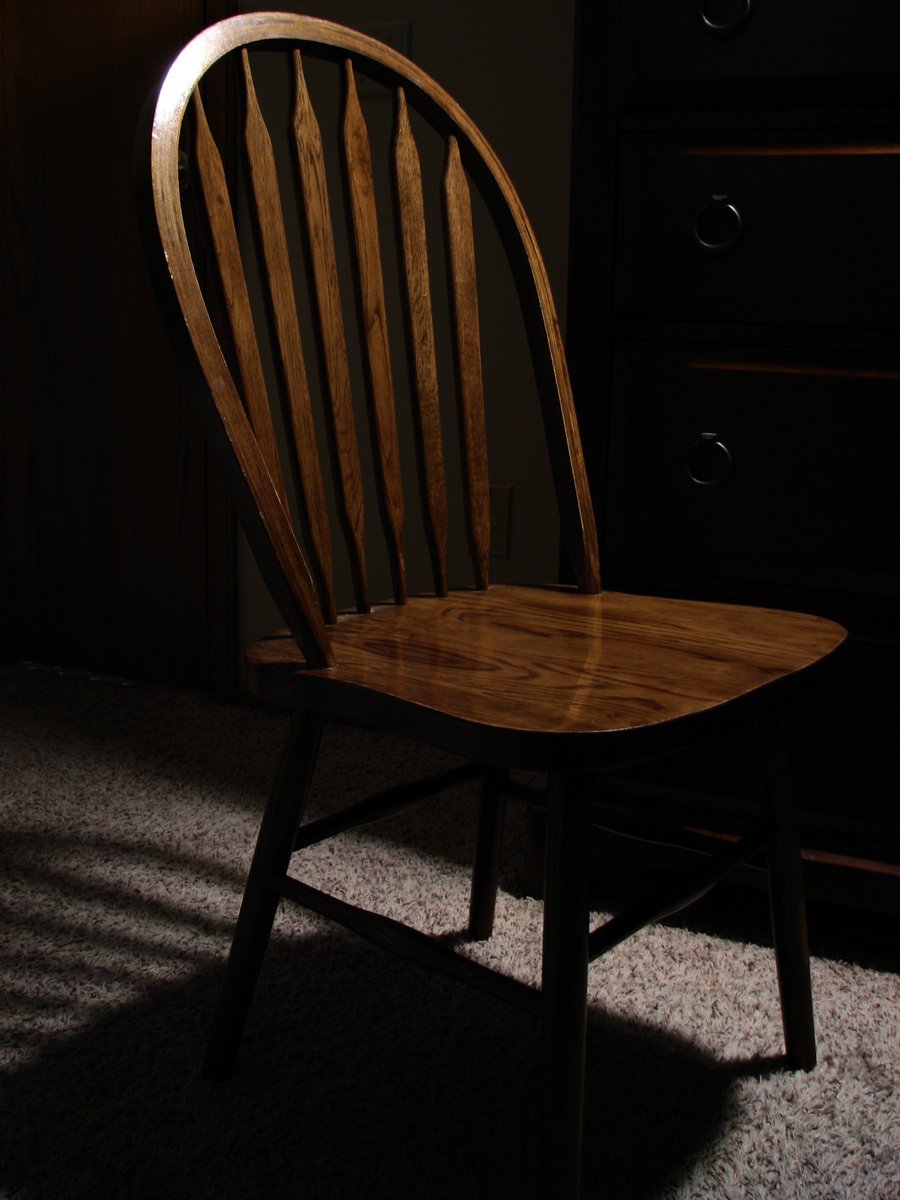 a wooden chair is sitting in a room