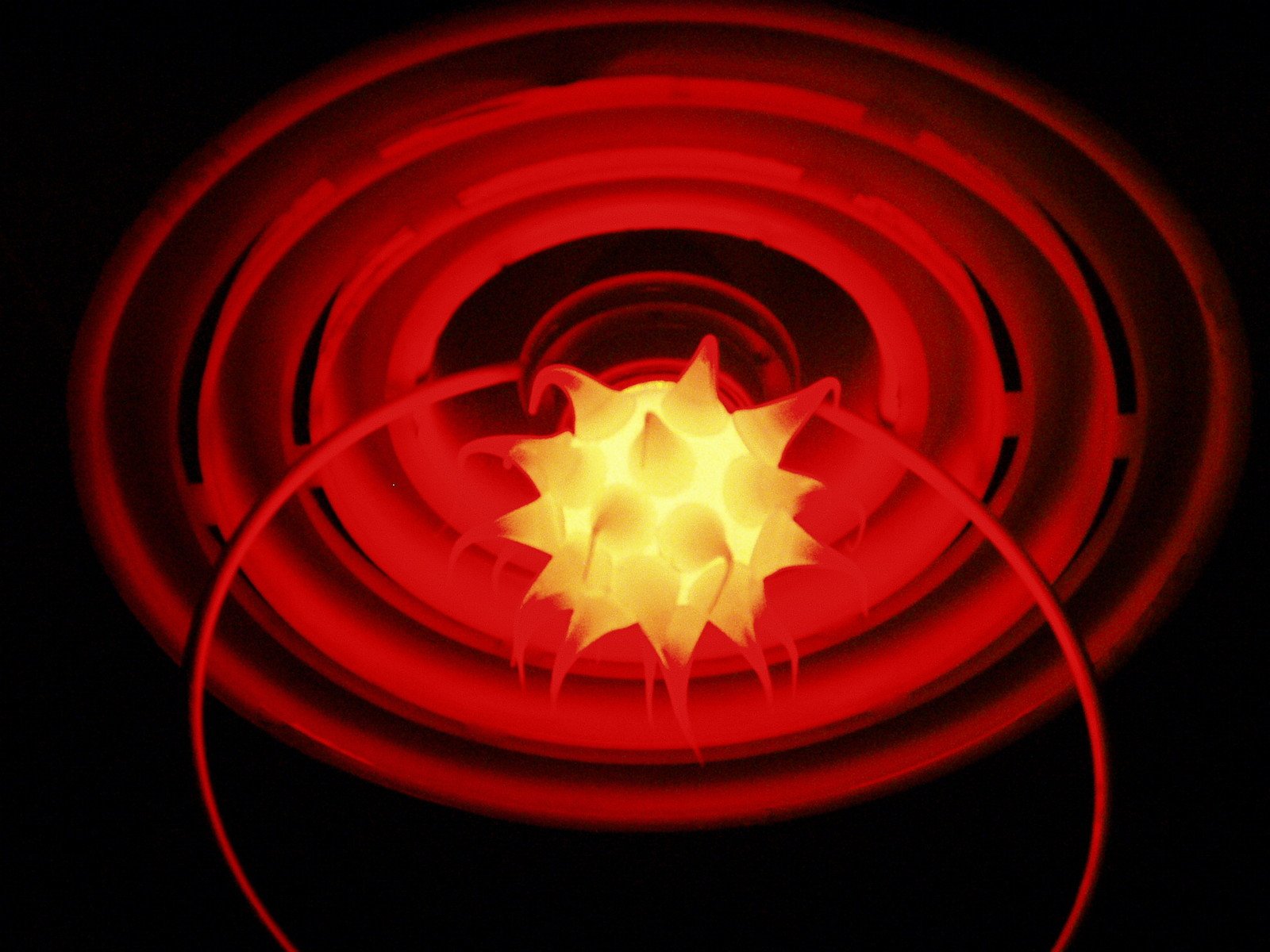 a red glowing object is against a black background