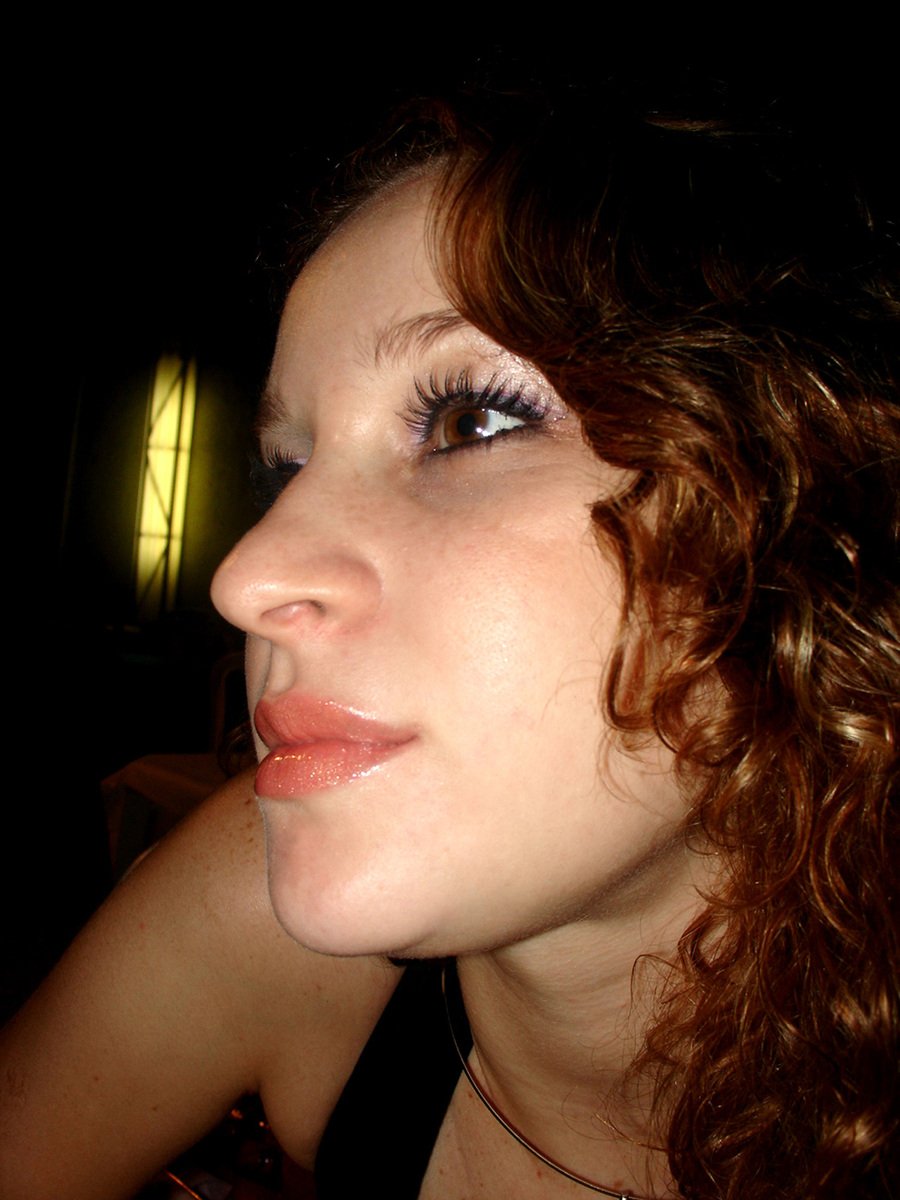 a close up of a woman with large brown hair