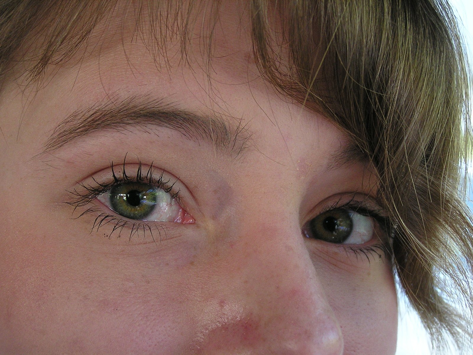 a close up of a woman with eyeliners on her face