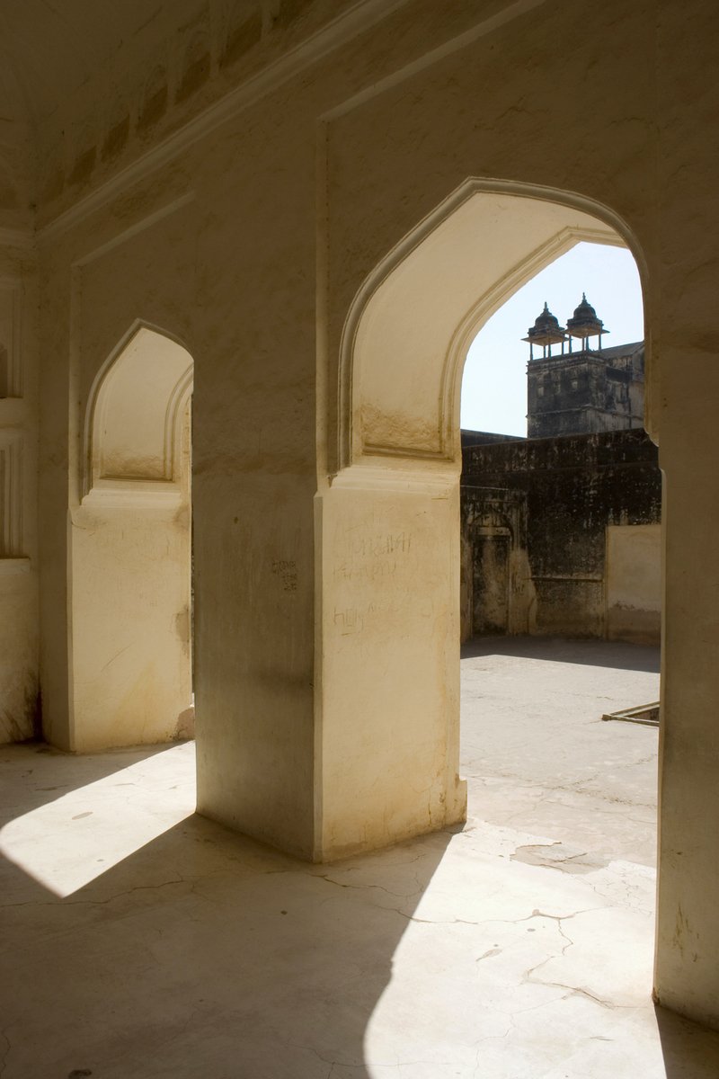 an archway opening to an inside walkway next to buildings