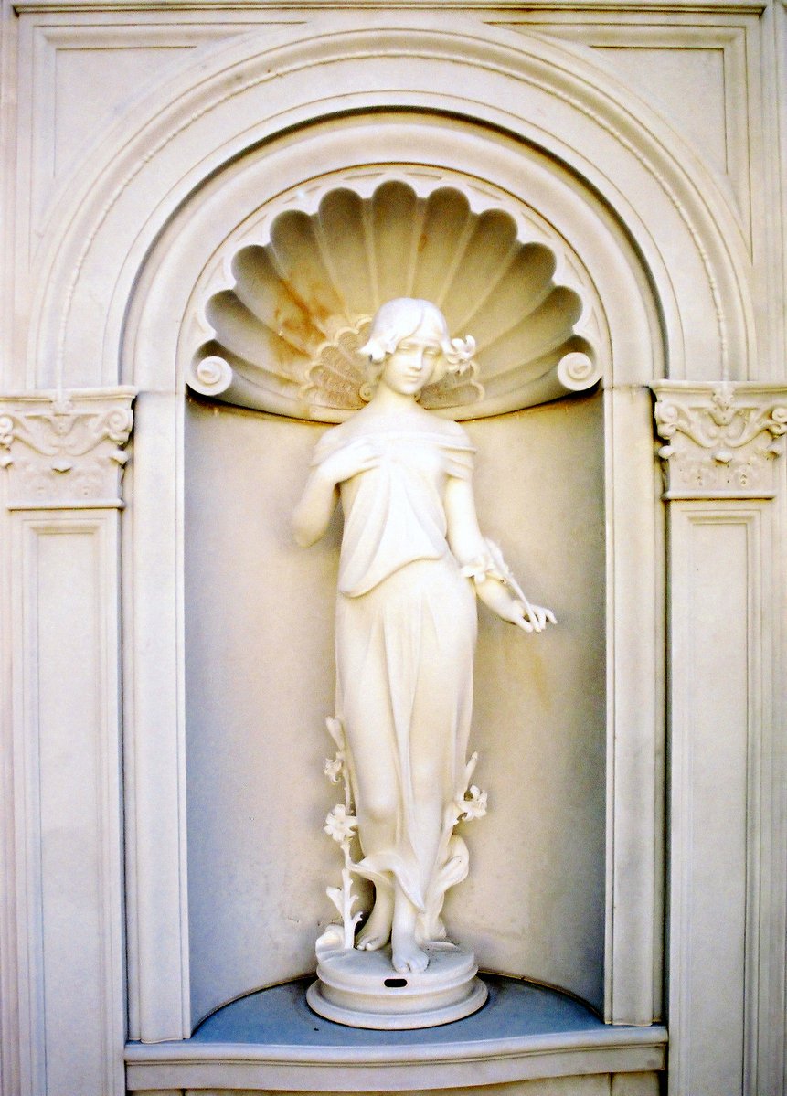 a statue of a  in a fountain surrounded by ornate doorway