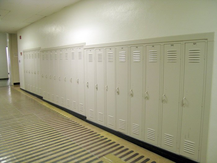 lockers lined up in a hallway that is empty