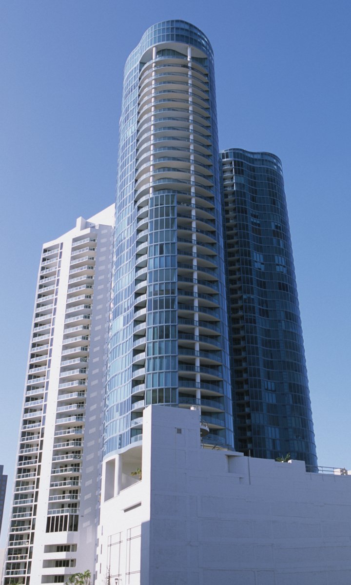 tall buildings are seen next to a building in a city