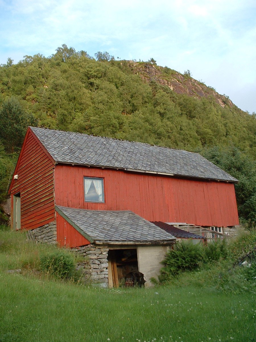 the barn is in the mountains with it's roof missing