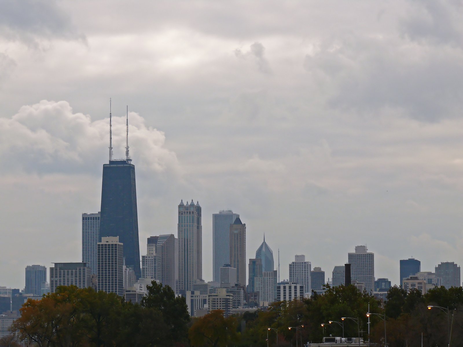 a tall building is seen with other buildings in the background